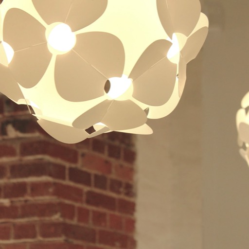 White spherical lamp with flower motif. Designer lampshade.